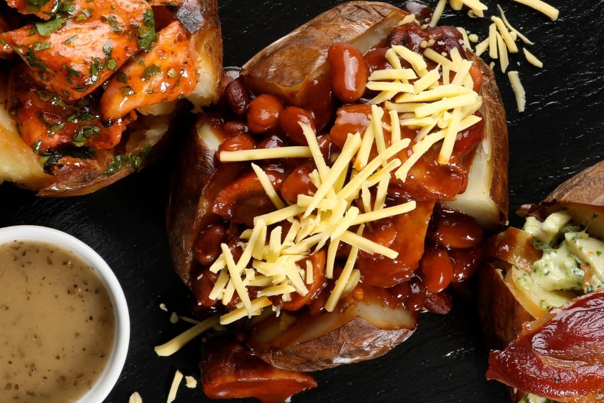 Loaded Jacket Potato with BBQ Boston Beans and Vegan Sausage